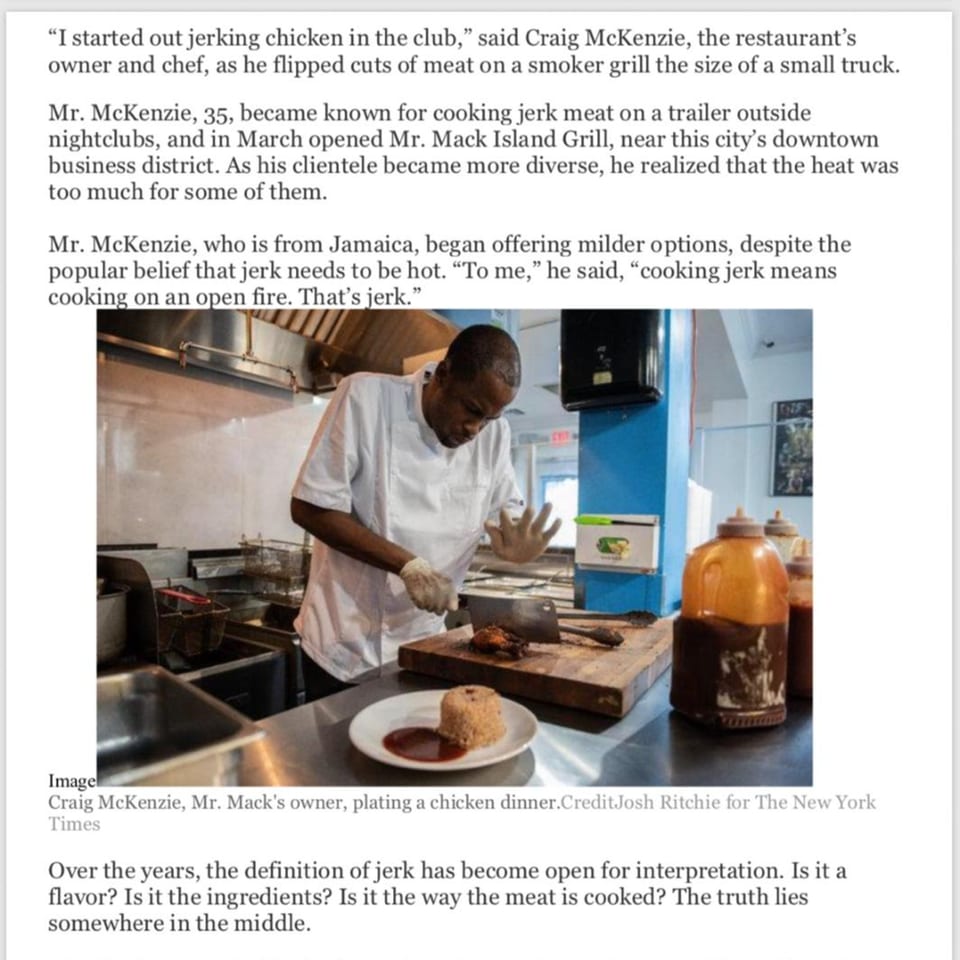 Mr. Mack's owner, Craig McKenzie, plating a Jamaican jerk chicken dinner in a commercial kitchen.
